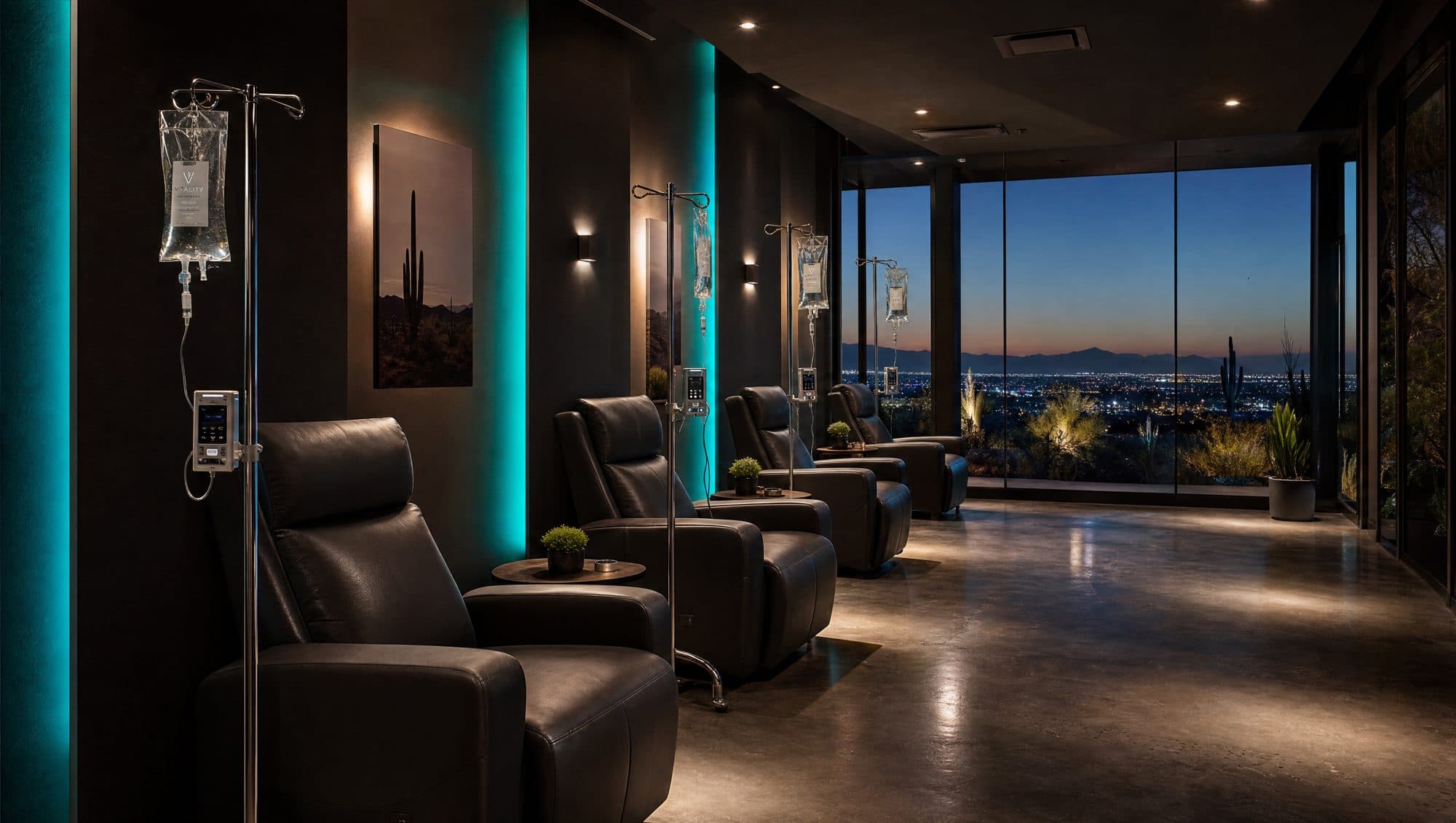 Teal-lit IV therapy lounge with leather recliners overlooking the Scottsdale skyline at dusk