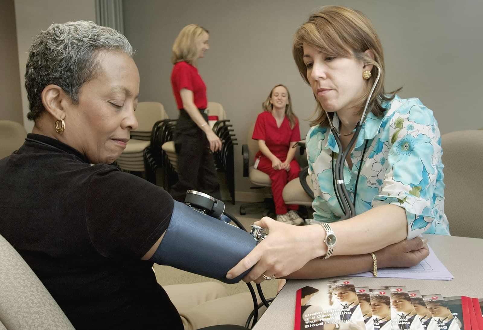 Nurse checking a client's vitals during a mobile IV visit
