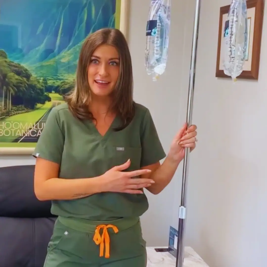 Recovery Room nurse holding an IV drip bag ready for an Ageless Beauty infusion